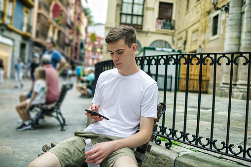 A young man using a mobile phone in Bilbao