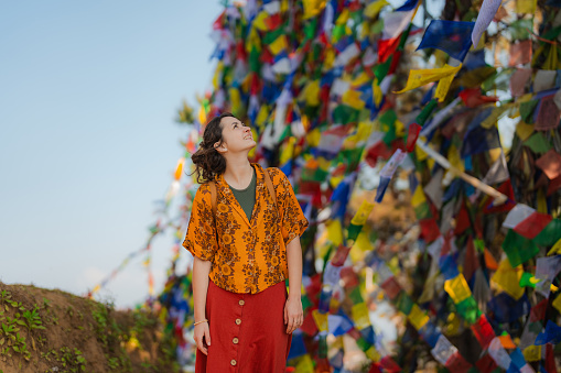 Young Caucasian woman  on the background of Tibetan prayer flags