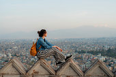 Woman sitting overlooking Kathmandu cityscape