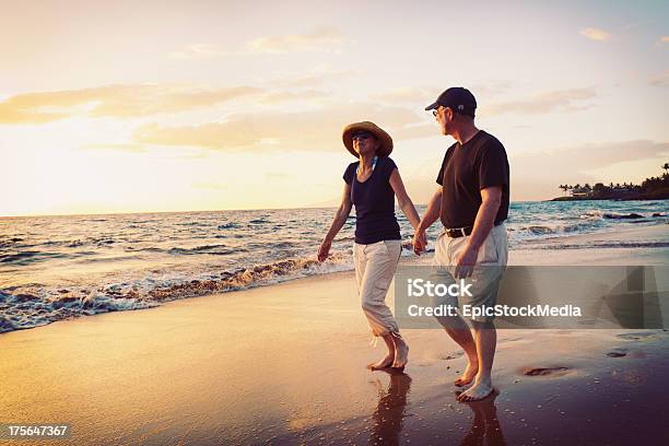 Senior Couple Enjoying Sunset At The Beach Stock Photo - Download Image Now - Active Seniors, Adult, Beach