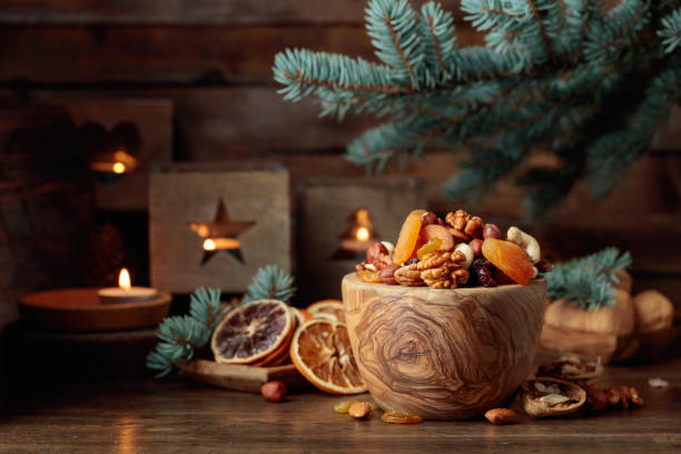 istock Dried fruits and assorted nuts on an old wooden table. 1756475457