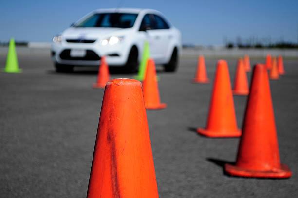 istock White Car and many traffic orange cones 175647782