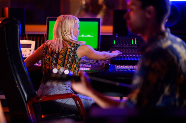 istock Music recording studio technician and guitar player in action, recording track. 1756480553