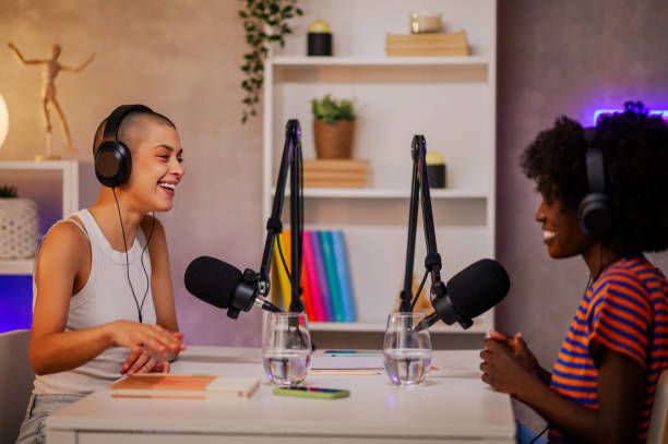 istock Two cheerful podcasters are sitting in a home broadcasting studio. 1756482392