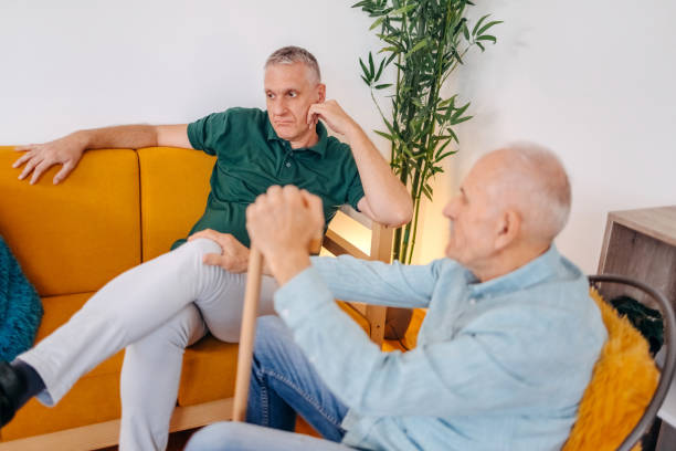 istock Old man giving support to his sad and disappointed middle age son at home 1756484514