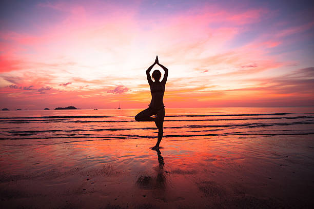 istock Young woman yoga practice at the seaside 175648525