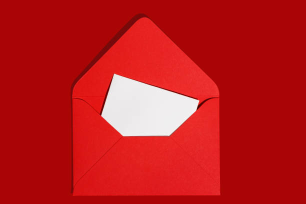 istock Christmas letter mockup. Blank white empty page and red paper envelope on red background. Postcard, greetings and thank you card template. 1756486212