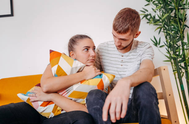 istock Young man giving support to his sad and disappointed girlfriend at home 1756488634