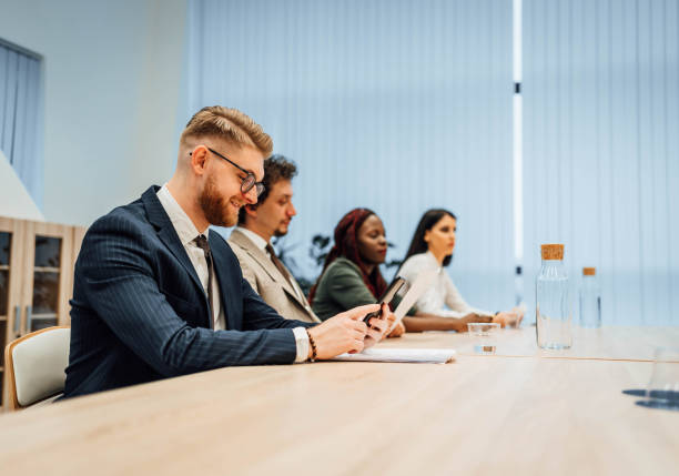 istock Businessman using phone during the meeting 1756492613