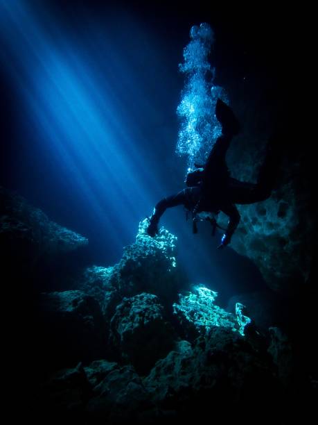 istock Lightbeams illuminate diver in the flooded underground cavern at Devil's Den, Williston Florida 1756505123