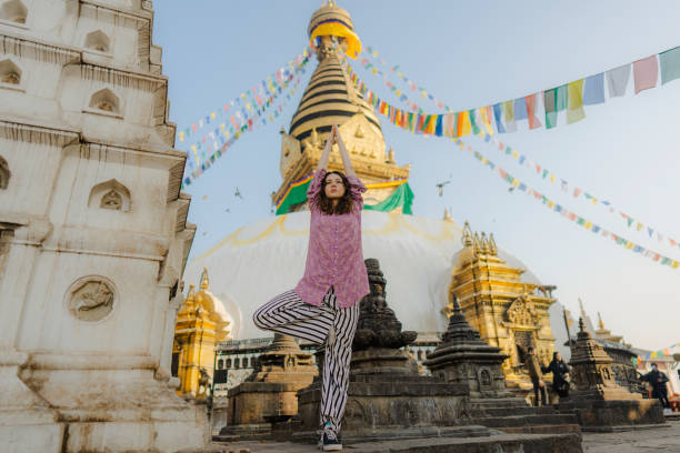 istock Woman doing tree pose on the background of stupa 1756506301
