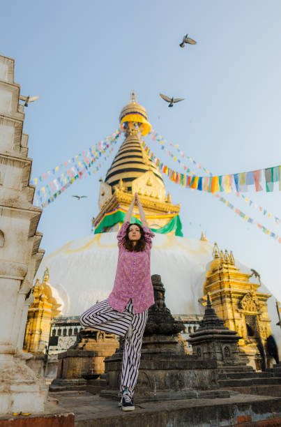 istock Woman doing tree pose on the background of stupa 1756509276