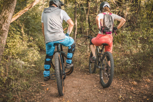 istock Back view of two best friends preparing to cycle down a steep mountain 1756523625