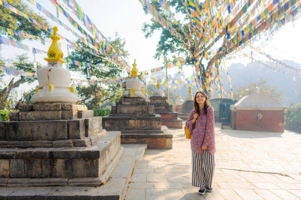 istock Woman standing under tibetan prayer flags 1756529720