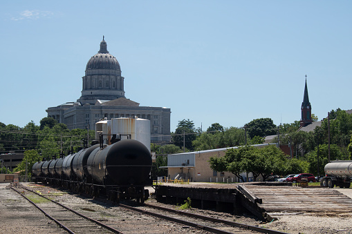 Black train composition on siding with Capitol in background in Jefferson City