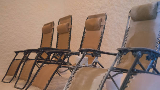 Salt room interior with armchairs and salt block wall in spa
