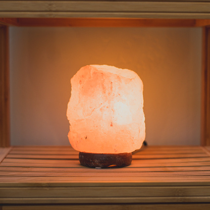 Glow salt lamp, sitting on a shelf