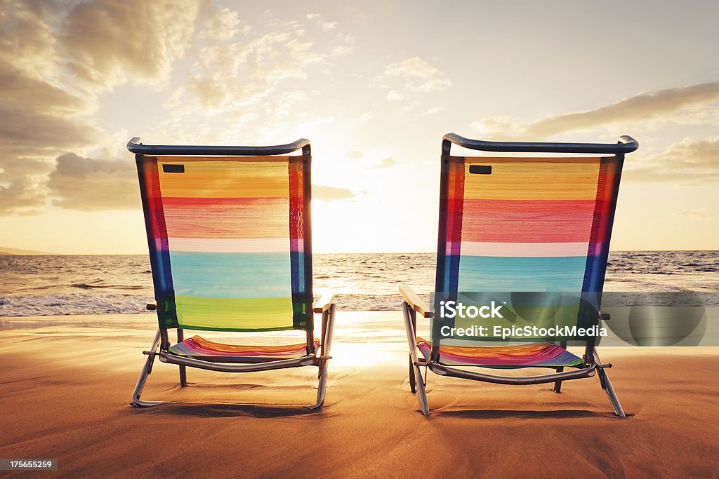 Hawaiian Vacation Sunset Concept Hawaiian Vacation Sunset Concept, Two Beach Chairs at Sunset Beach Stock Photo