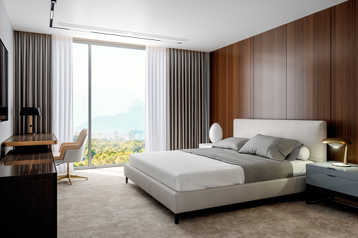 3d rendering of a comfortable bed in a luxury hotel suite.  Computer generated image of interior of a luxurious hotel room.