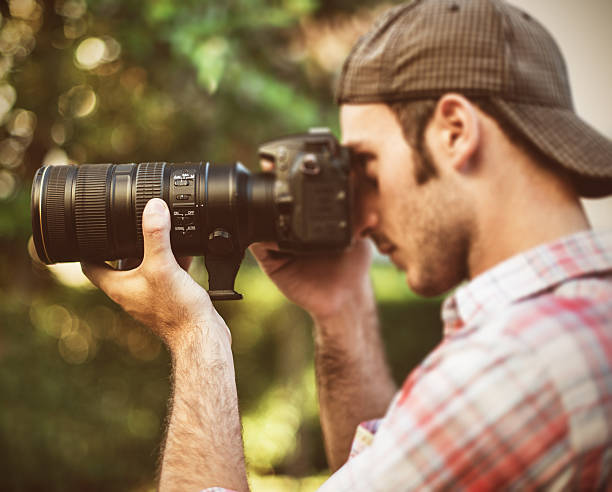 istock Photographer taking a picture with long lens 175656969