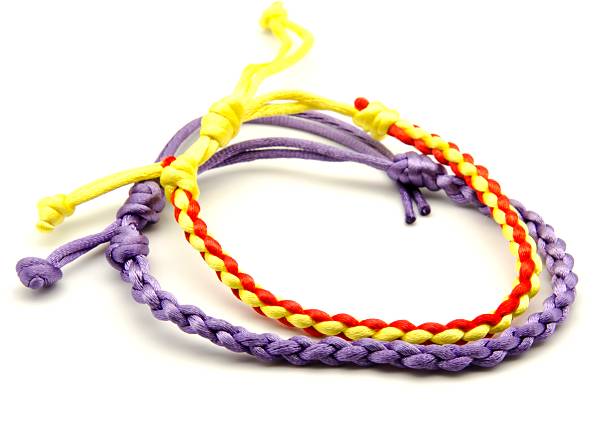 An isolated ethnic bracelet on white background. The bracelet is made off the various rope