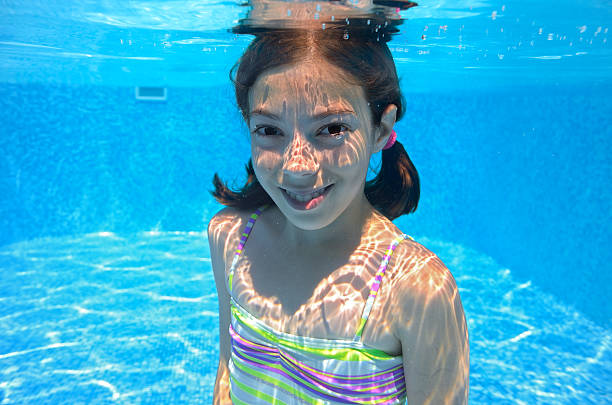 istock Happy active child swims underwater in pool 175657463