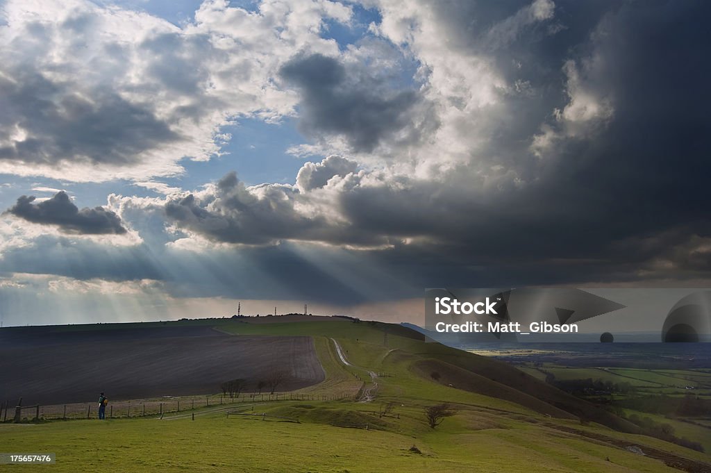 Sttunning scene across escarpment countryside landscape with beautiful clouds formations Beautiful countryside landscape across rolling hills with lovely cloud formations Agricultural Field Stock Photo