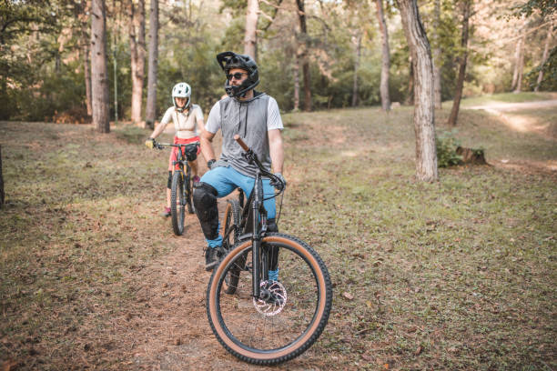 istock Two friends with helmets are riding bicycles on the mountain 1756576087