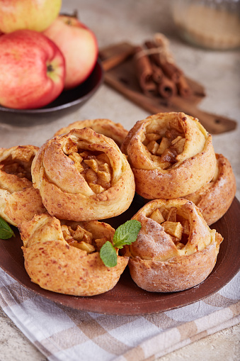 Rose shaped mini open pies with apples and cinnamon. Delicious homemade sweet buns.