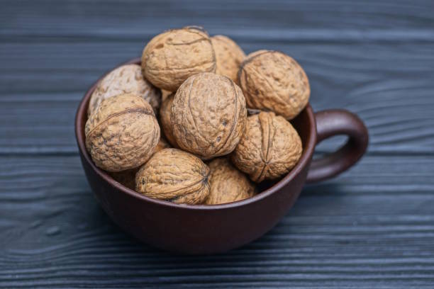 istock a bunch of walnuts in a brown ceramic cup 1756598299