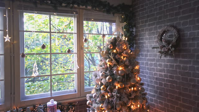 Decorated Christmas Tree Near Fireplace at Home