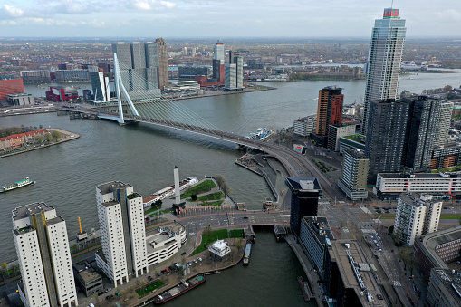 The Skyline of Rotterdam City with the river meuse captured on a cloudy day during summer season.