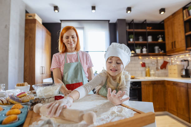 istock Mother and daughter making sweets in the kitchen 1756642835