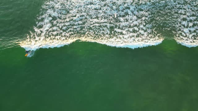 Seen from above two surfers surfing the same wave,Cascais,Portugal- top down, drone shot
