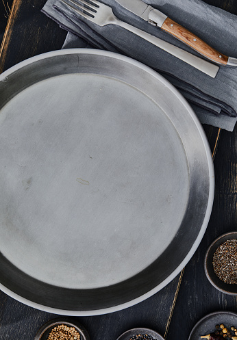 Empty round wooden plate on white wooden table. Perfect as food display.