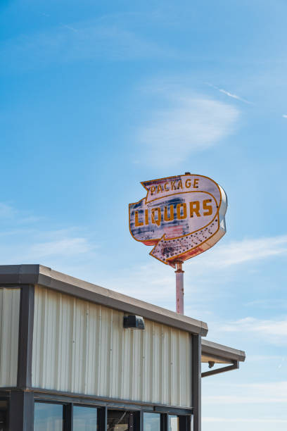 istock Old rusted package liquor store sign on bright clear day 1756661267