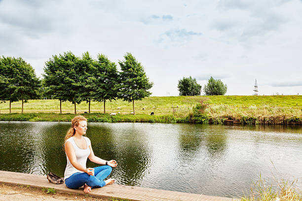 istock relaxation young redhead woman outdoors at river 175668152