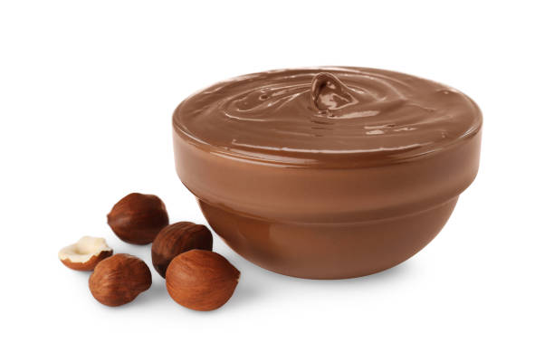istock Bowl with delicious chocolate paste and hazelnuts on white background 1756682541