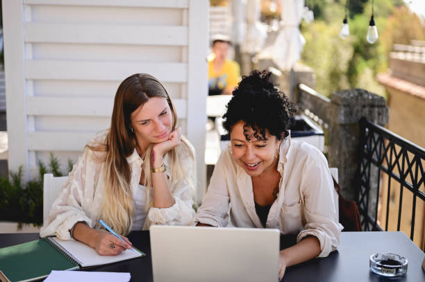 istock Businesspeople having video call in outdoors cafe. 1756688432