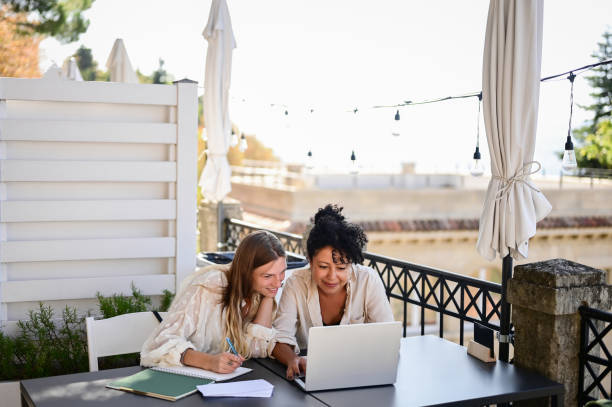 istock Two female friends studying outdoors in remote location. 1756688433