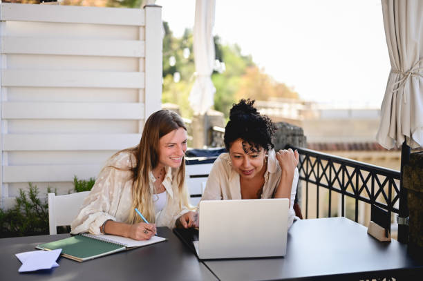 istock two cheerful multiracial adult student  using laptop. 1756688434