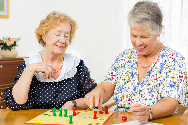 istock Senior women couple playing board game ludo 175669000