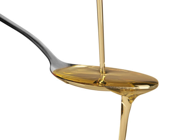 istock Pouring cooking oil into spoon on white background 1756696590