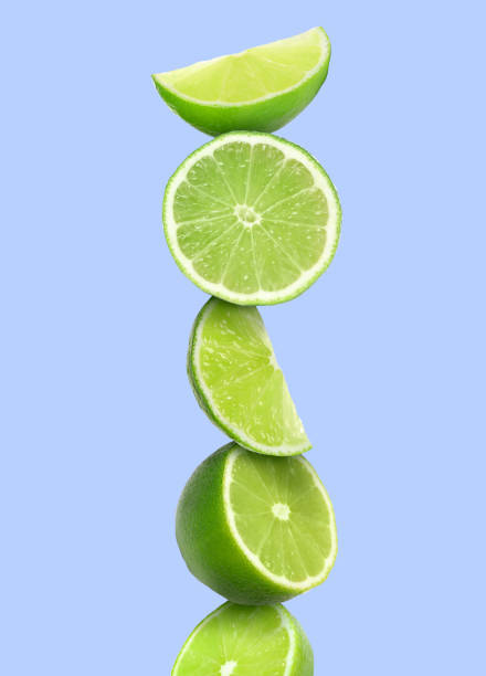 istock Stacked cut limes on light pale blue background 1756697126