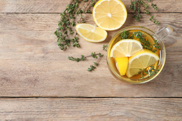 istock Aromatic herbal tea with thyme and lemon on wooden table, flat lay. Space for text 1756697656