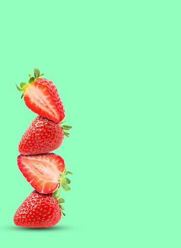 Stack of fresh strawberries on aquamarine background, space for text