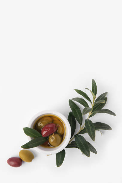 istock Bowl with different ripe olives and leaves on white background, flat lay. Space for text 1756700909