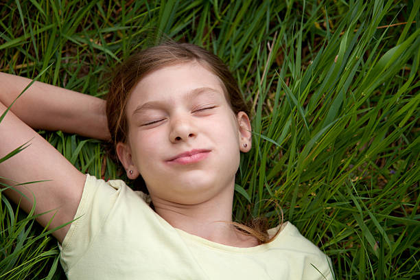 istock Girl lying on a meadow in nature 175671299