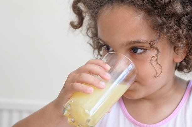 istock Little Girl (7-8) Drinking Orange Juice For Breakfast 175674180