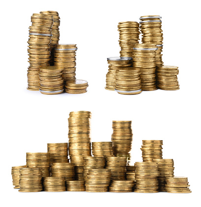 Rising stacks of coins. Isolated on white.